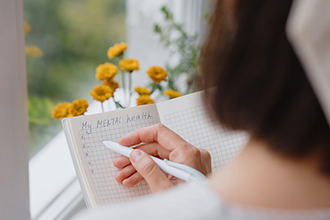 Client writing their mental health diary